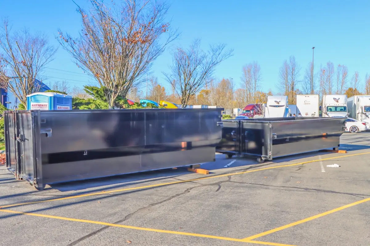 Professional dumpster rental service with roll-off container on residential driveway in Evanston